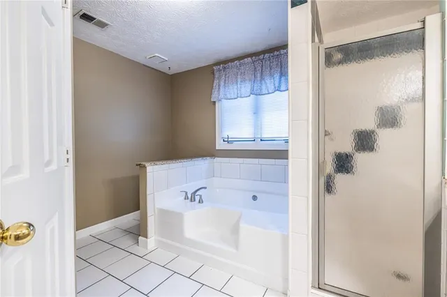 an empty room with a window and a ceiling fan