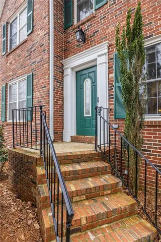 a view of a house with wooden deck