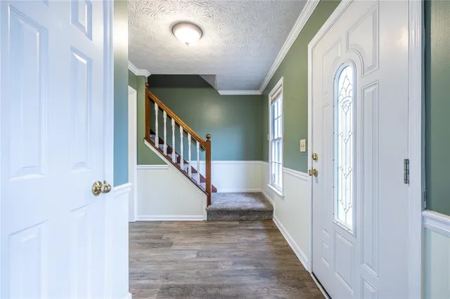 a view of an entryway with wooden floor