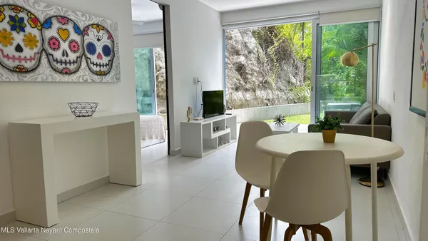 a view of a dining room that has a table and a chair in it