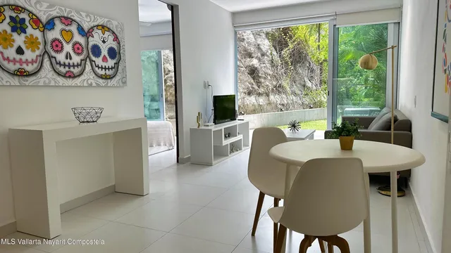 a view of a dining room that has a table and a chair in it