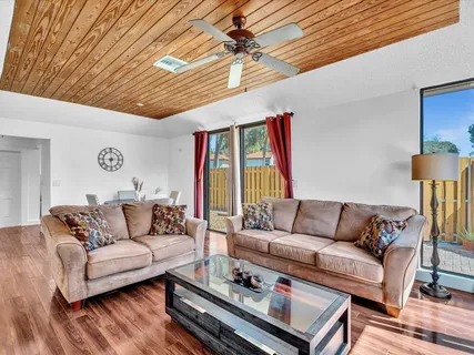 a living room with furniture a fireplace and a table
