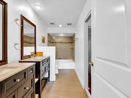 a bathroom with a sink a mirror and a shower