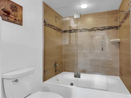 a bathroom with a bathtub and a shower