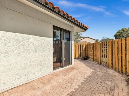 a view of a wooden house with wooden fence