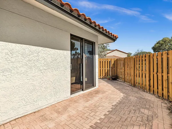 a view of a wooden house with wooden fence