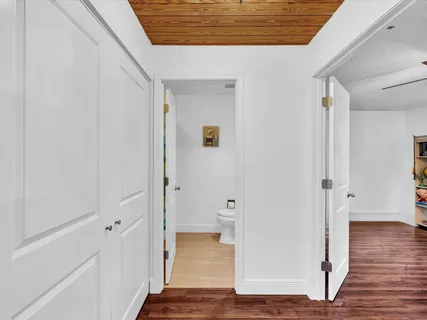 a view of a hallway with wooden floor