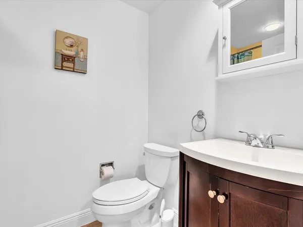 a bathroom with a sink mirror and toilet
