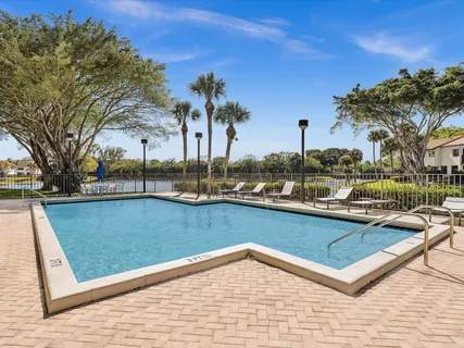 a view of a swimming pool with a lounge chairs