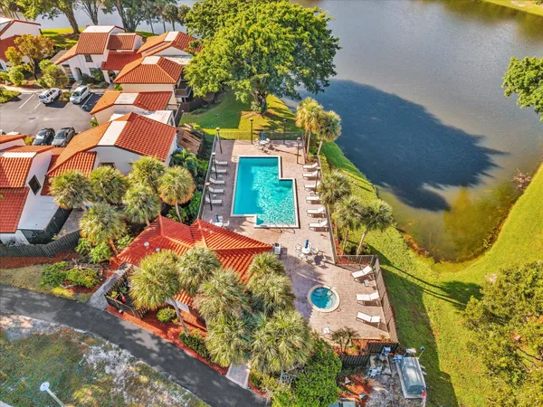 an aerial view of a house with a yard and garden