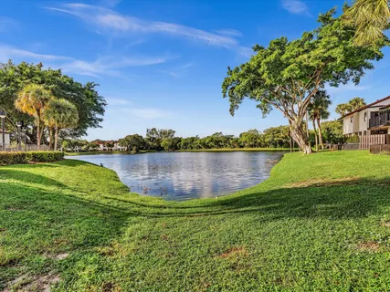 a view of a lake with houses in the back