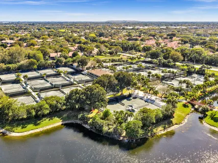 an aerial view of residential houses with outdoor space and trees