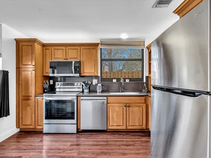 a kitchen with a refrigerator a stove a microwave and cabinets