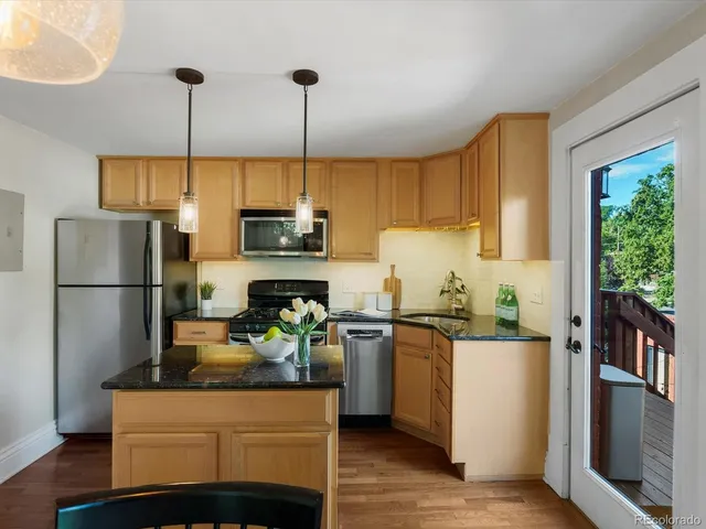a kitchen with kitchen island a counter top space appliances and cabinets
