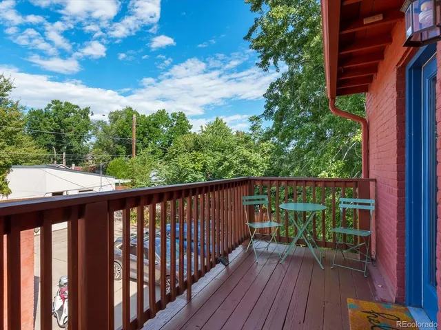 a balcony with wooden floor and outdoor space
