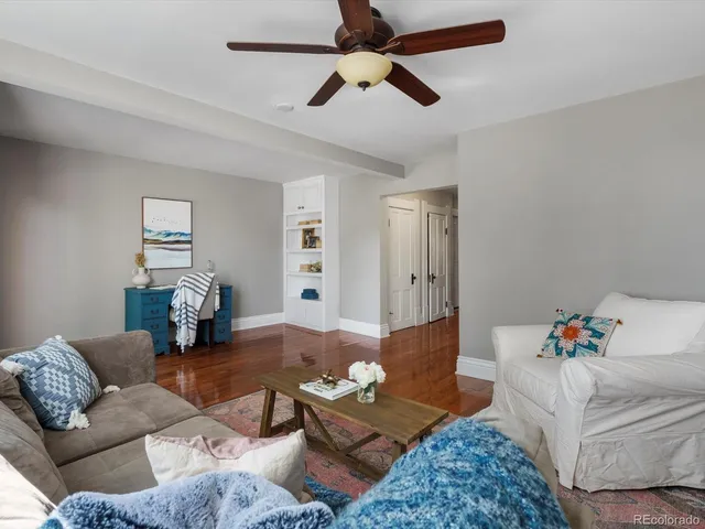 a living room with furniture and wooden floor