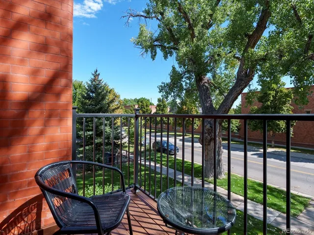 a view of a balcony with outdoor seating