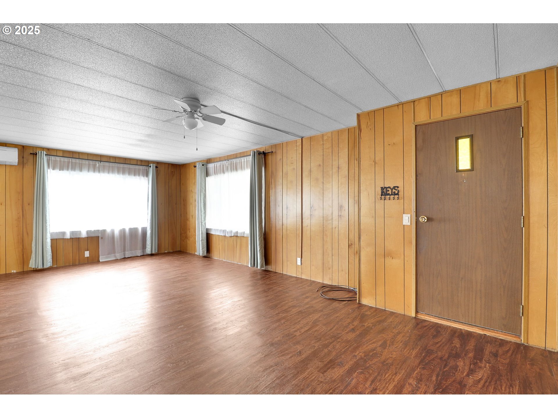3900 Coburg Road, Unit 59 Eugene, OR 97408 - Photo 11 of 30 a view of empty room with wooden floor and fan