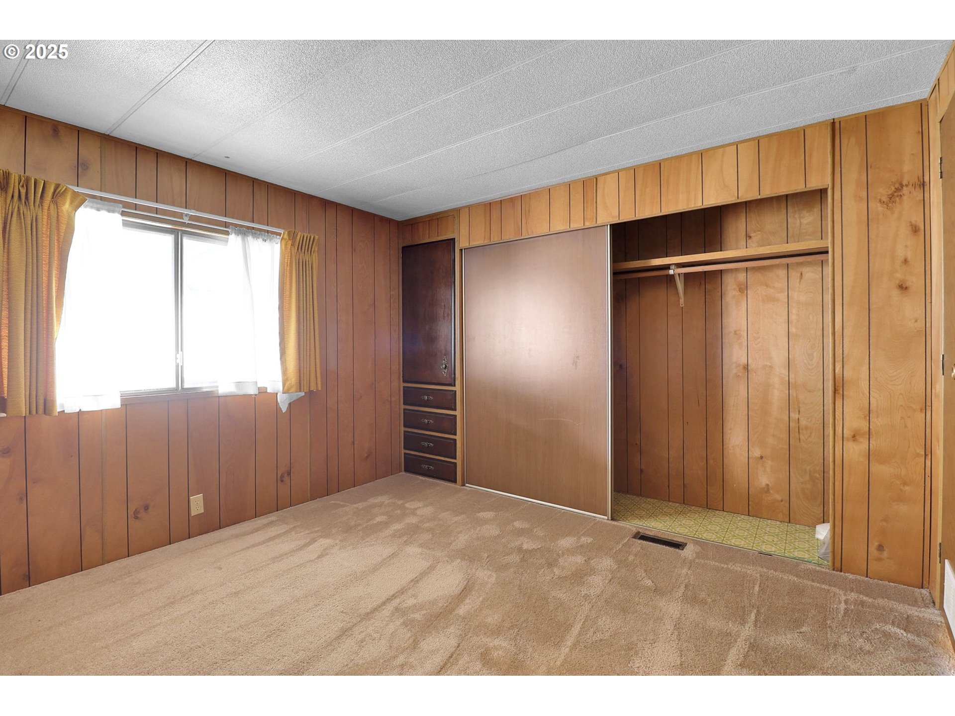 3900 Coburg Road, Unit 59 Eugene, OR 97408 - Photo 15 of 30 a view of an empty room with wooden floor and a window