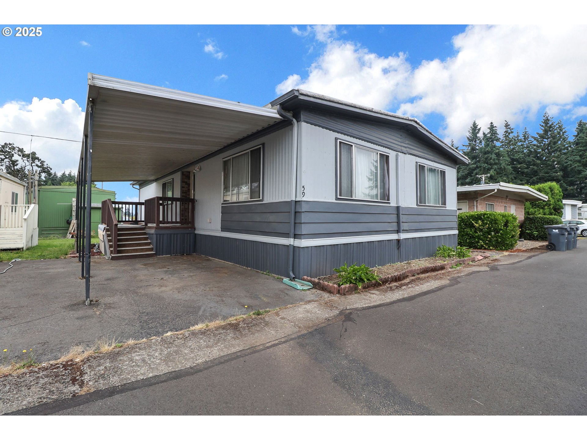 3900 Coburg Road, Unit 59 Eugene, OR 97408 - Photo 2 of 30 a front view of a house with a yard and garage