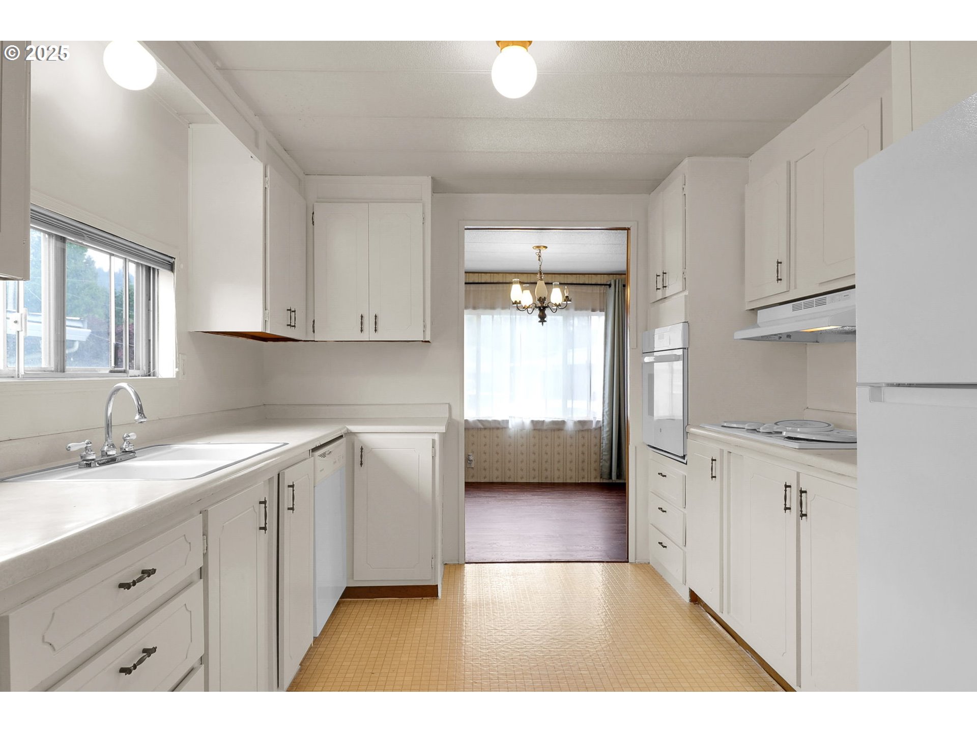 3900 Coburg Road, Unit 59 Eugene, OR 97408 - Photo 4 of 30 a kitchen with granite countertop a sink stainless steel appliances and cabinets