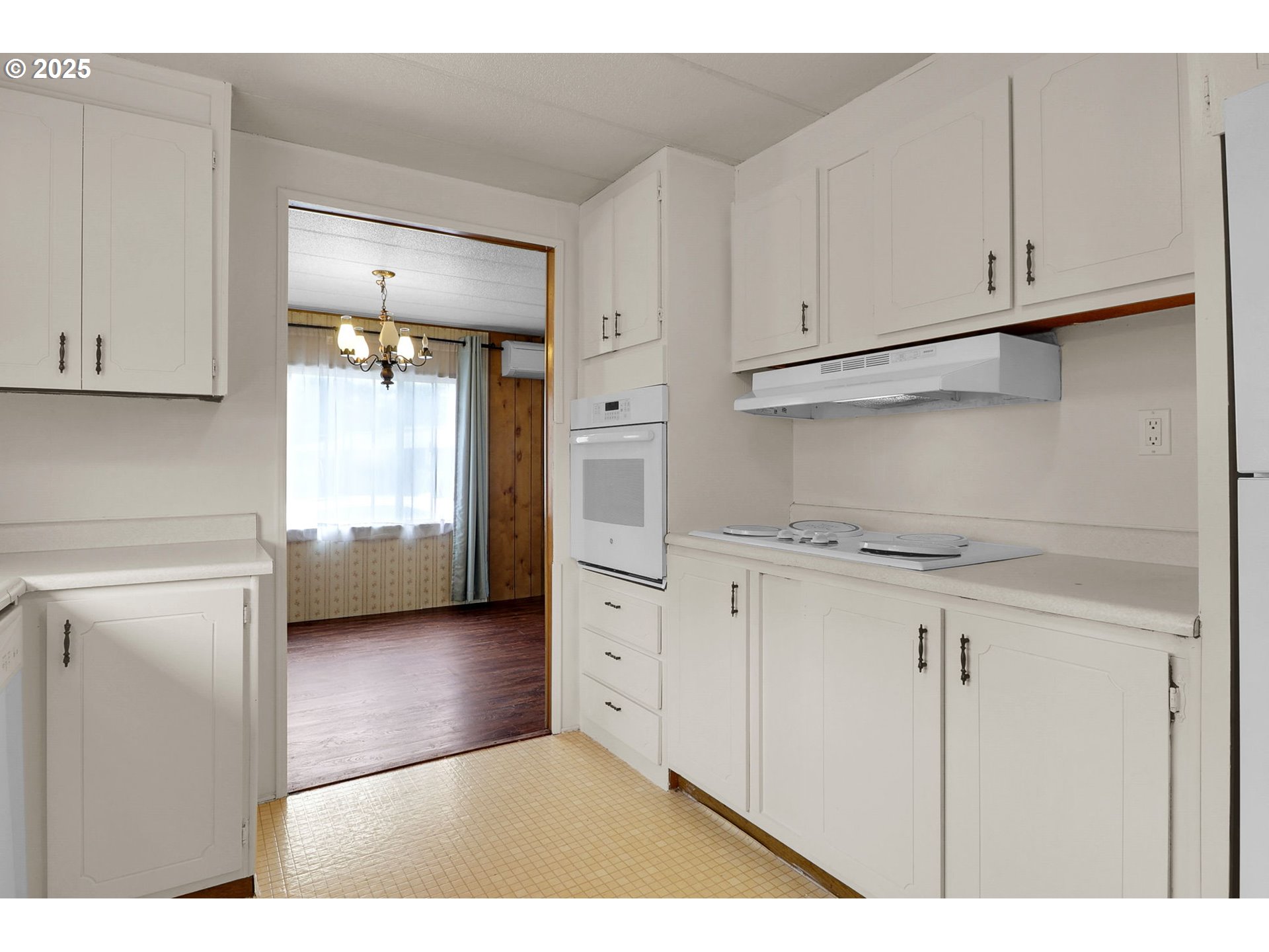 3900 Coburg Road, Unit 59 Eugene, OR 97408 - Photo 5 of 30 a kitchen with white cabinets and a stove