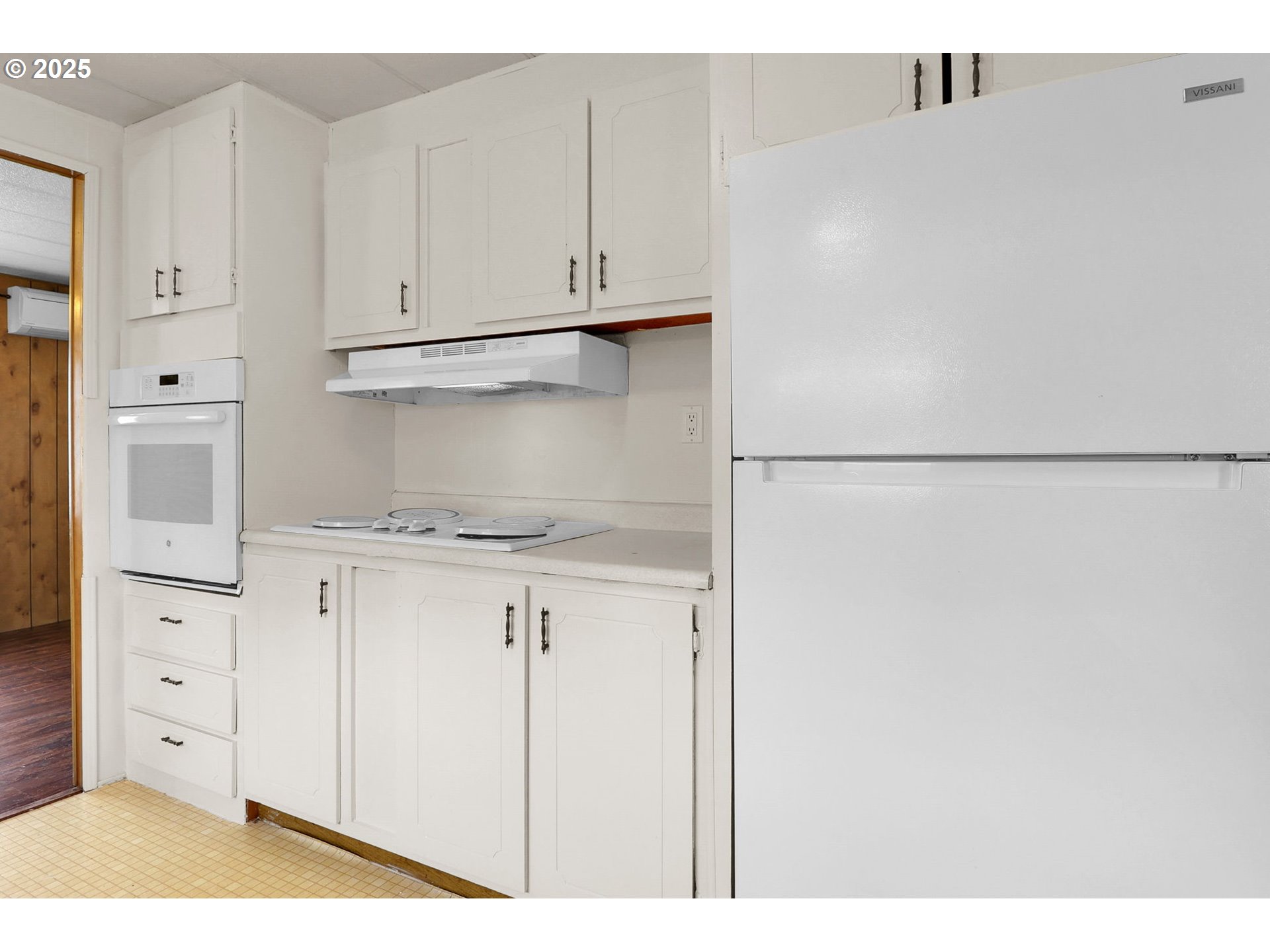 3900 Coburg Road, Unit 59 Eugene, OR 97408 - Photo 6 of 30 a kitchen with white cabinets and white appliances