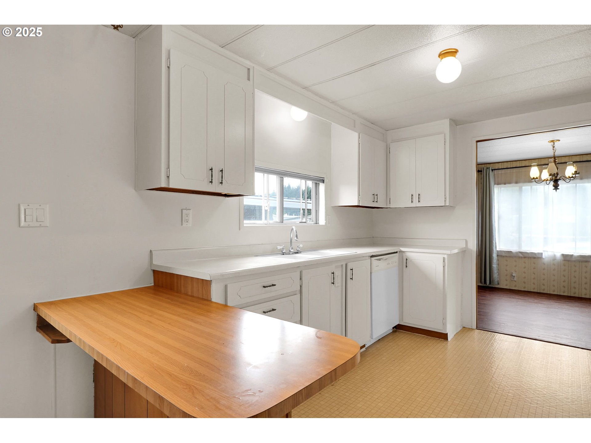 3900 Coburg Road, Unit 59 Eugene, OR 97408 - Photo 7 of 30 a kitchen with cabinets and wooden floor