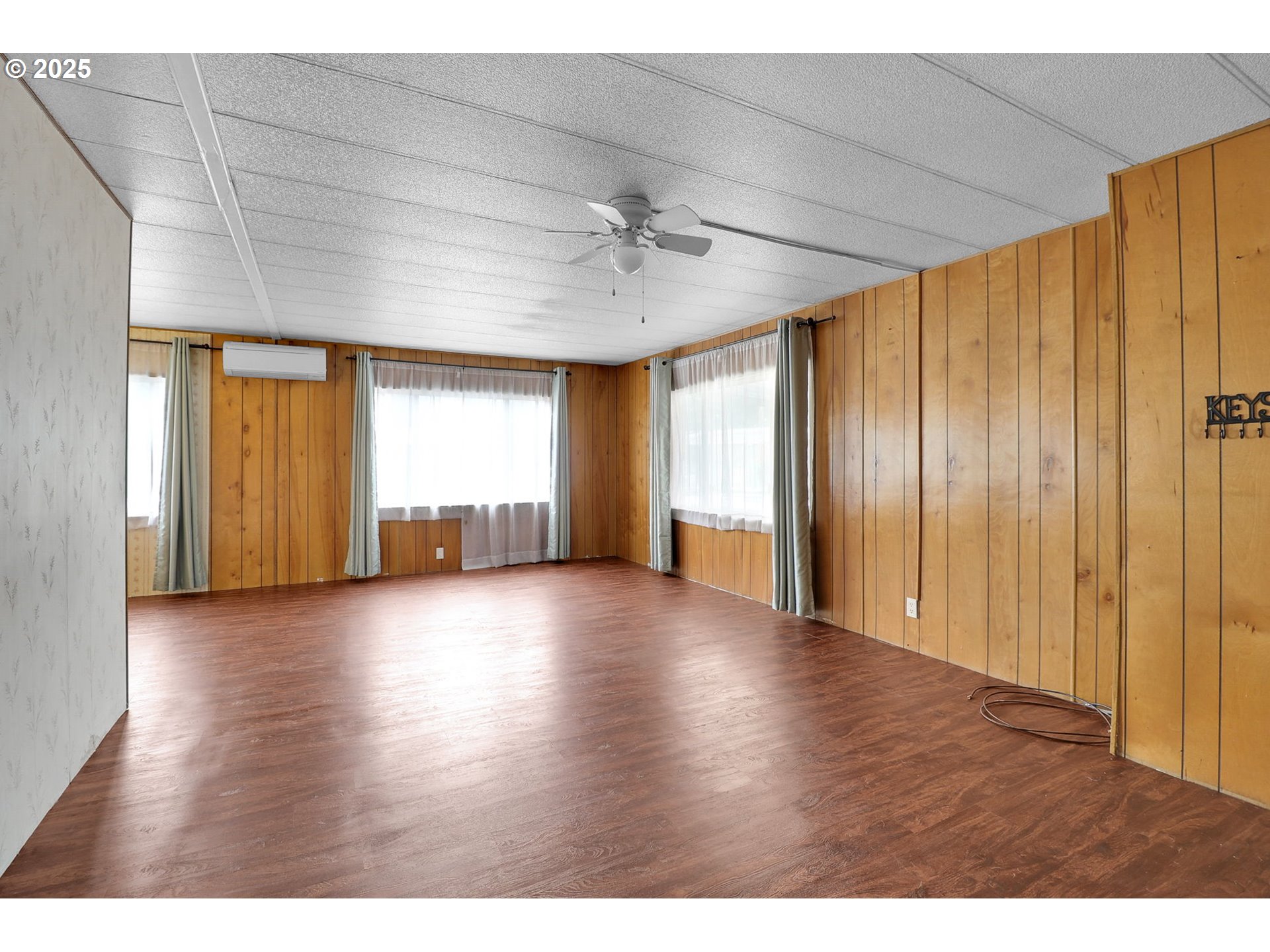 3900 Coburg Road, Unit 59 Eugene, OR 97408 - Photo 10 of 30 a view of an empty room with a window and wooden floor