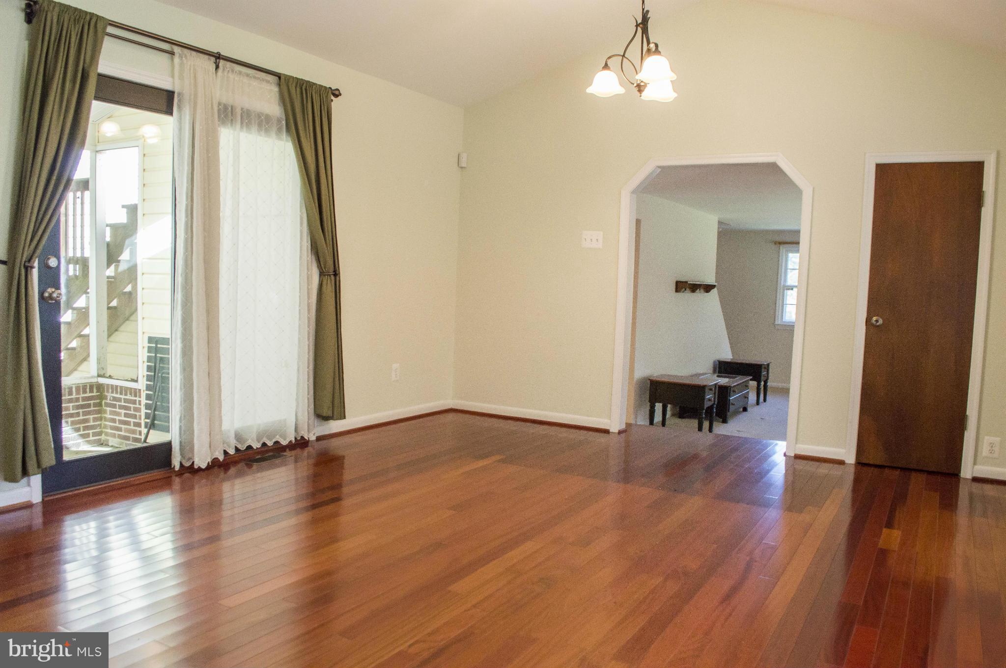 2050 Holland Cliffs Road Huntingtown, MD 20639 - Photo 16 of 29 a view of an empty room with wooden floor and a window