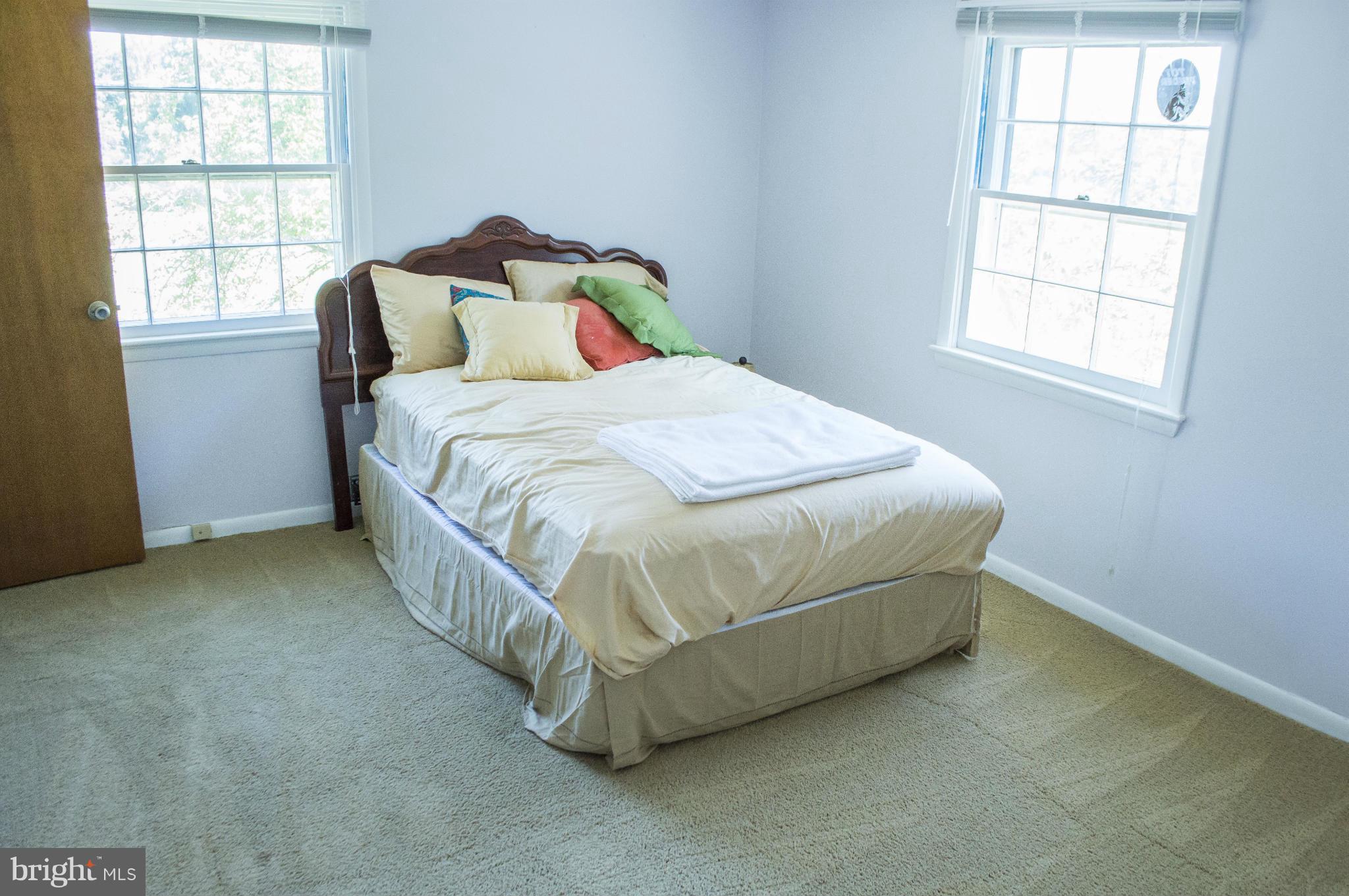 2050 Holland Cliffs Road Huntingtown, MD 20639 - Photo 22 of 29 a bed sitting in a bedroom next to a window