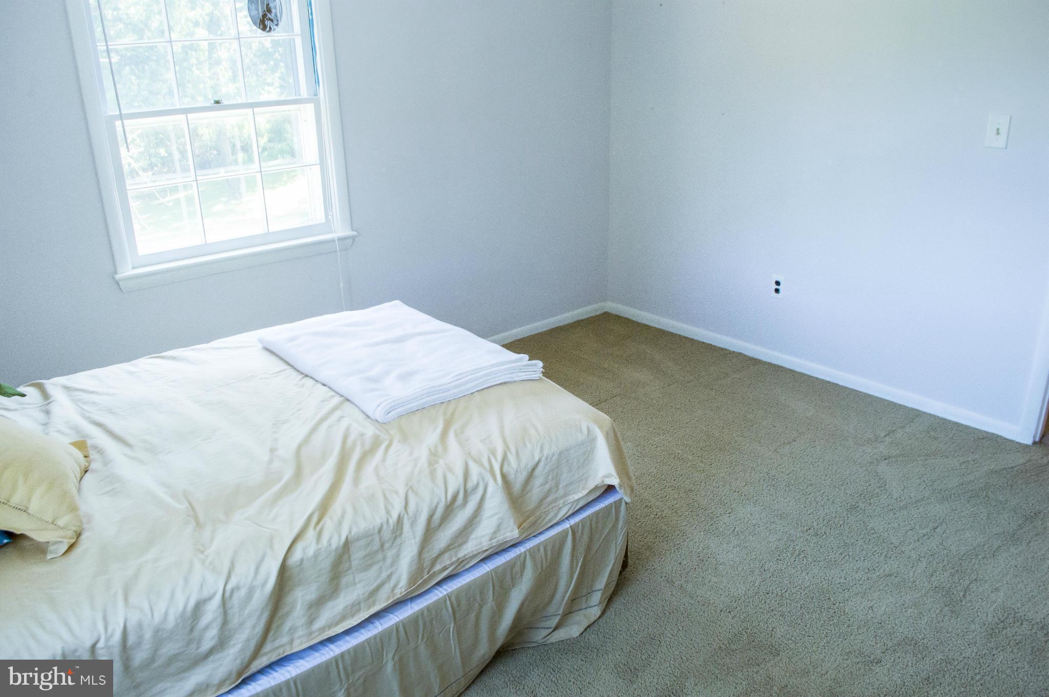 2050 Holland Cliffs Road Huntingtown, MD 20639 - Photo 23 of 29 a bed sitting in a bedroom next to a window