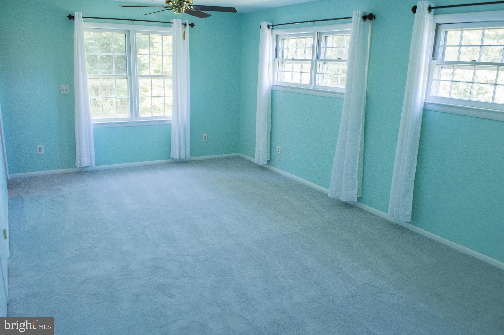 2050 Holland Cliffs Road Huntingtown, MD 20639 - Photo 24 of 29 an empty room with windows
