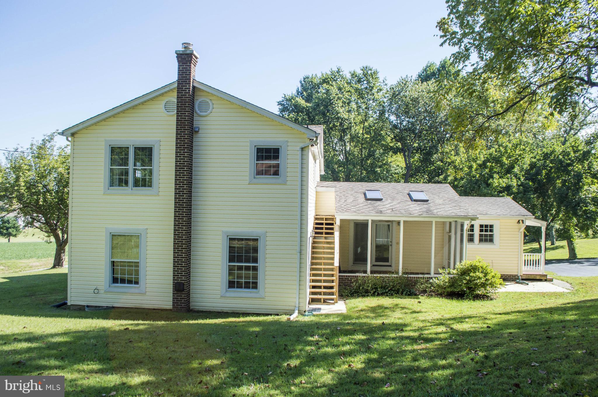 2050 Holland Cliffs Road Huntingtown, MD 20639 - Photo 5 of 29 a front view of a house with a yard