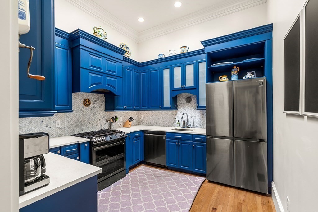 10 Forrester Street, Unit 2 Salem, MA 01970 - Photo 14 of 40 a kitchen with stainless steel appliances granite countertop a refrigerator a sink dishwasher a stove with wooden cabinets and floor