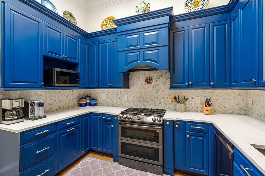 10 Forrester Street, Unit 2 Salem, MA 01970 - Photo 16 of 40 a kitchen with granite countertop wooden cabinets and stainless steel appliances