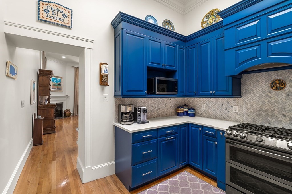 10 Forrester Street, Unit 2 Salem, MA 01970 - Photo 17 of 40 a kitchen with stainless steel appliances granite countertop wooden cabinets and a stove top oven