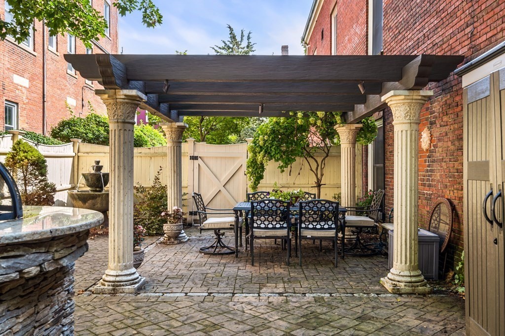 10 Forrester Street, Unit 2 Salem, MA 01970 - Photo 31 of 40 a backyard of a house with a fountain swing table and chairs