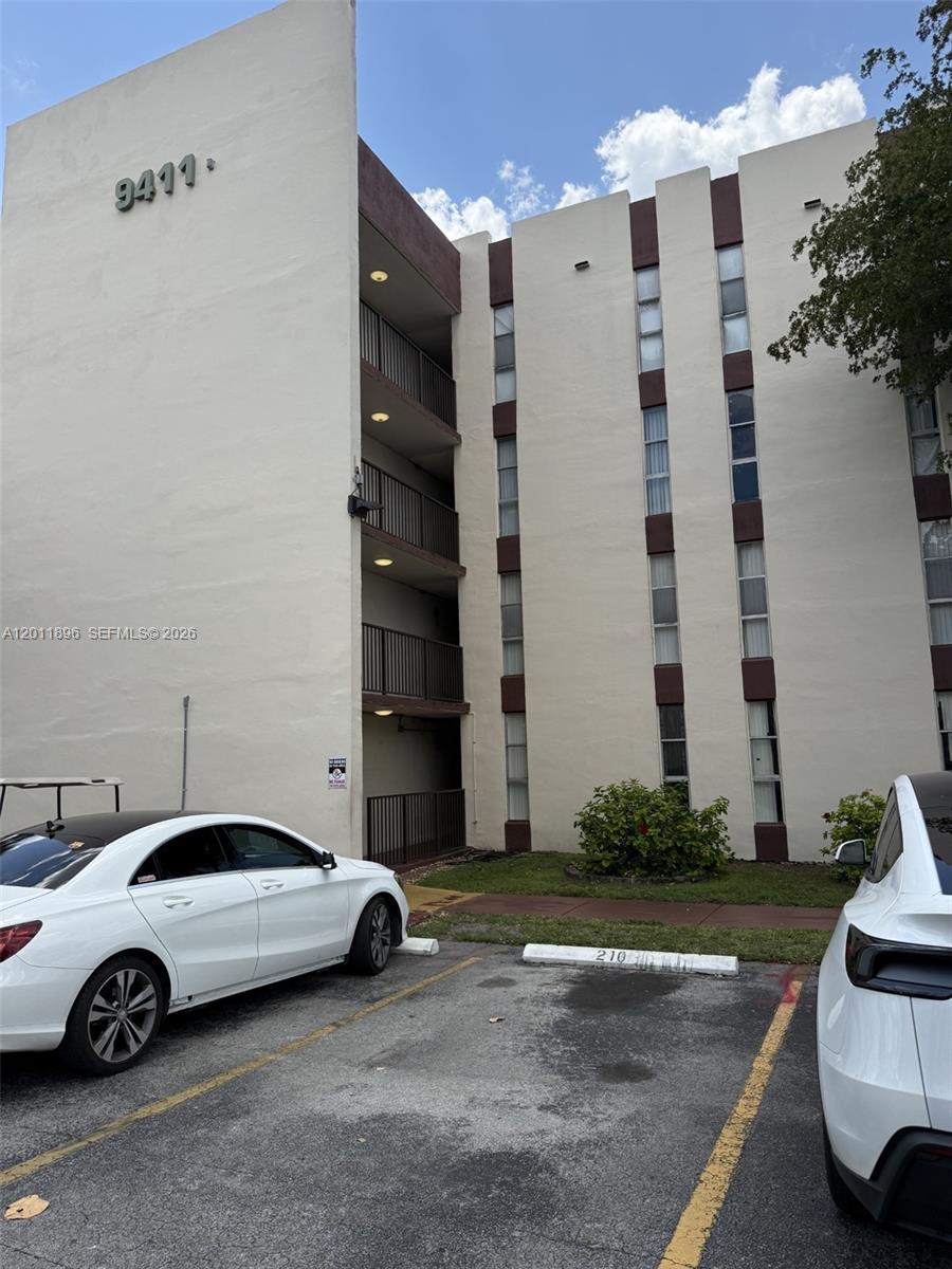 9411 Southwest 4th Street, Unit 111 Miami, FL 33174 - Photo 1 of 20 a white car parked in front of a building