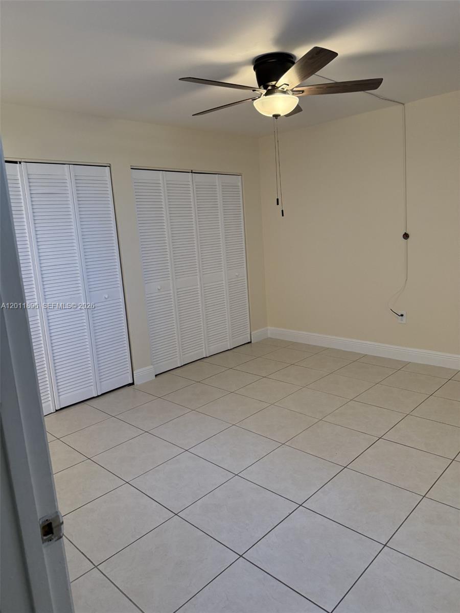 9411 Southwest 4th Street, Unit 111 Miami, FL 33174 - Photo 11 of 20 a view of room with a ceiling fan