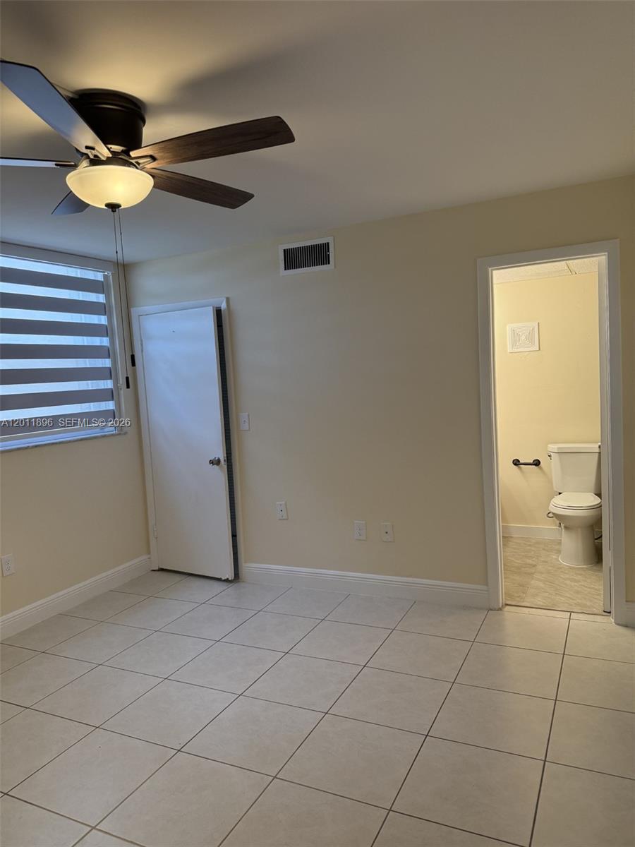 9411 Southwest 4th Street, Unit 111 Miami, FL 33174 - Photo 12 of 20 a view of an empty room and a chandelier fan