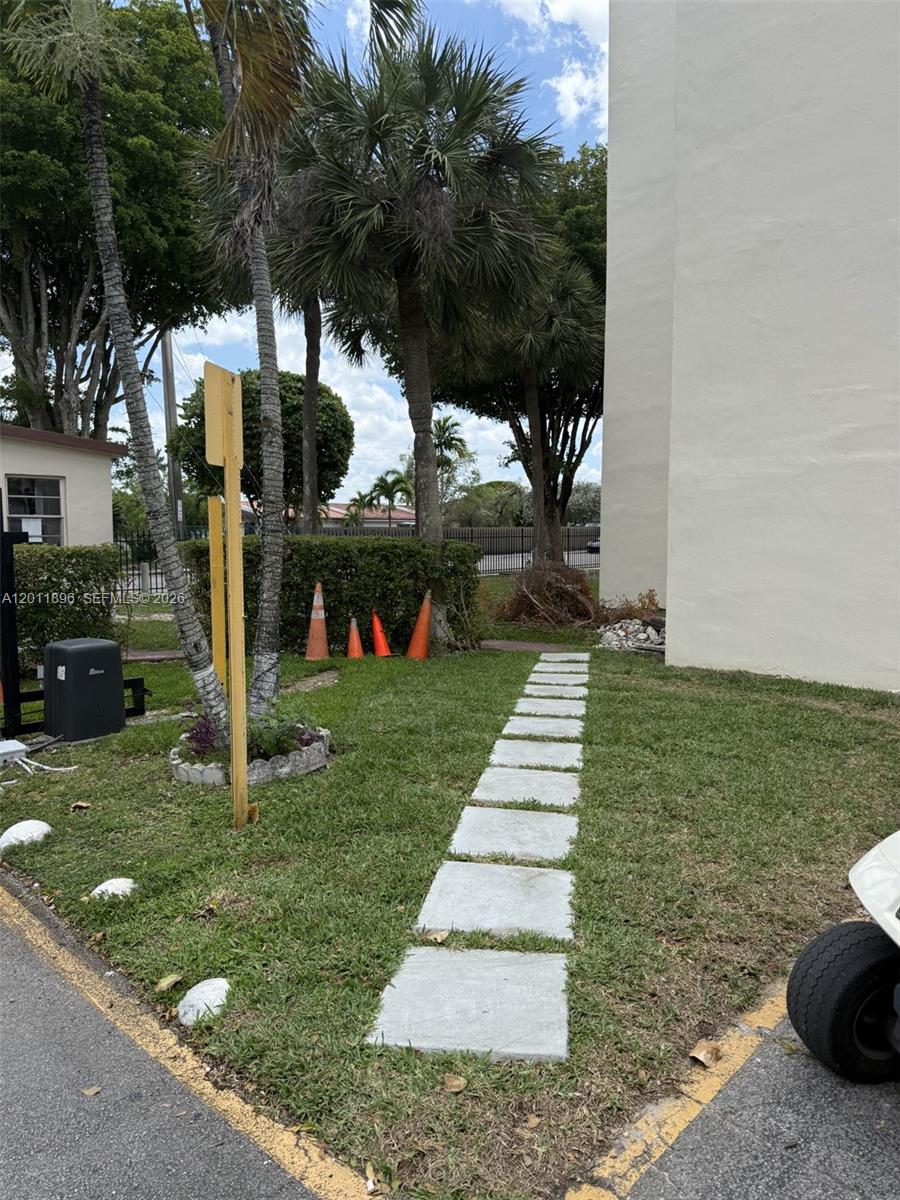 9411 Southwest 4th Street, Unit 111 Miami, FL 33174 - Photo 17 of 20 a front view of a house with garden