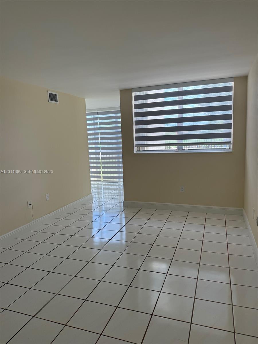 9411 Southwest 4th Street, Unit 111 Miami, FL 33174 - Photo 2 of 20 a view of an empty room and a window