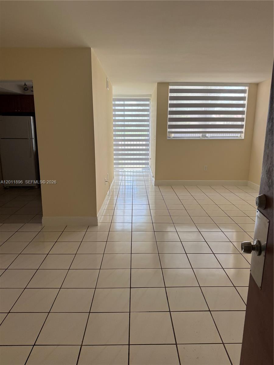 9411 Southwest 4th Street, Unit 111 Miami, FL 33174 - Photo 3 of 20 a view of an empty room and a window