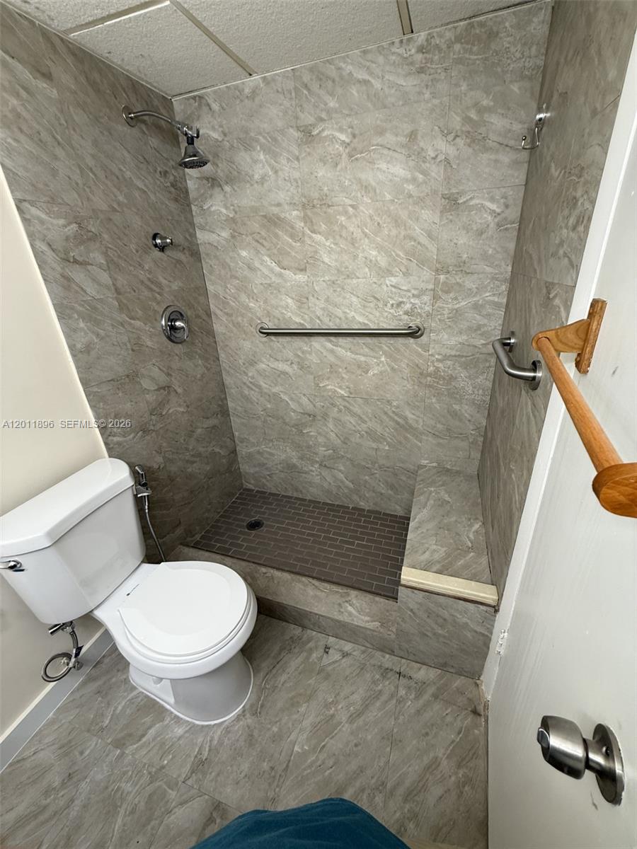 9411 Southwest 4th Street, Unit 111 Miami, FL 33174 - Photo 8 of 20 a bathroom with a toilet and a shower