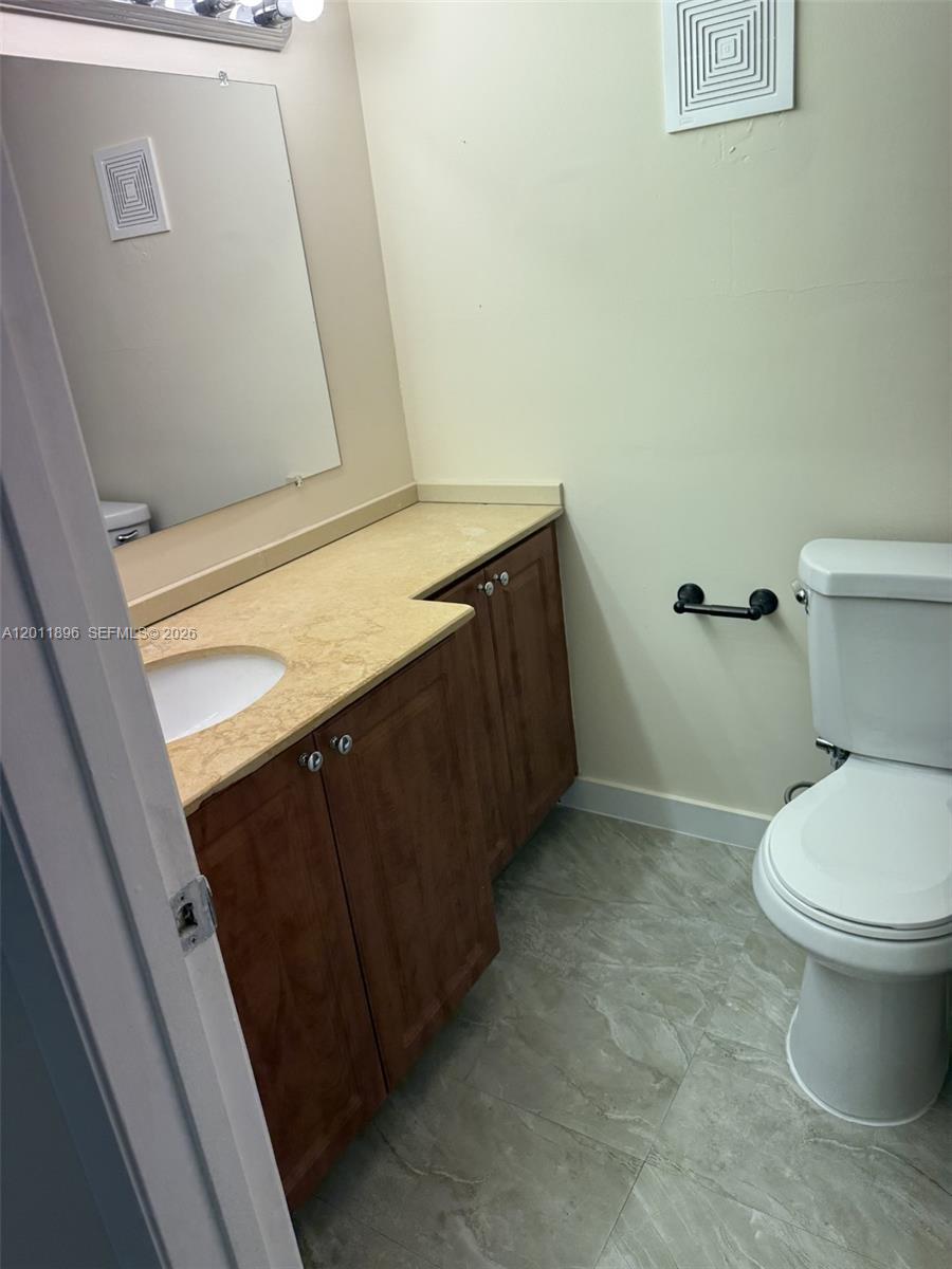9411 Southwest 4th Street, Unit 111 Miami, FL 33174 - Photo 9 of 20 a bathroom with a sink and a toilet