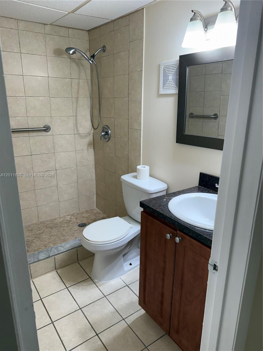 9411 Southwest 4th Street, Unit 111 Miami, FL 33174 - Photo 10 of 20 a bathroom with a sink a toilet and shower