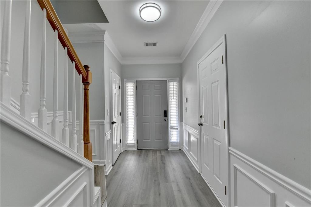3977 Howell Park Road Duluth, GA 30096 - Photo 7 of 25 a view of a hallway with wooden floor and staircase