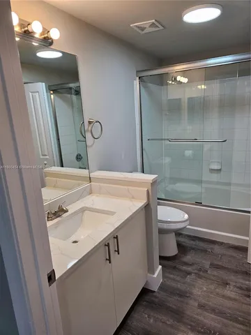 a bathroom with sink a mirror and a shower