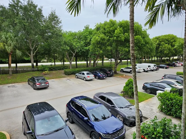 a view of a backyard with swimming pool and chairs